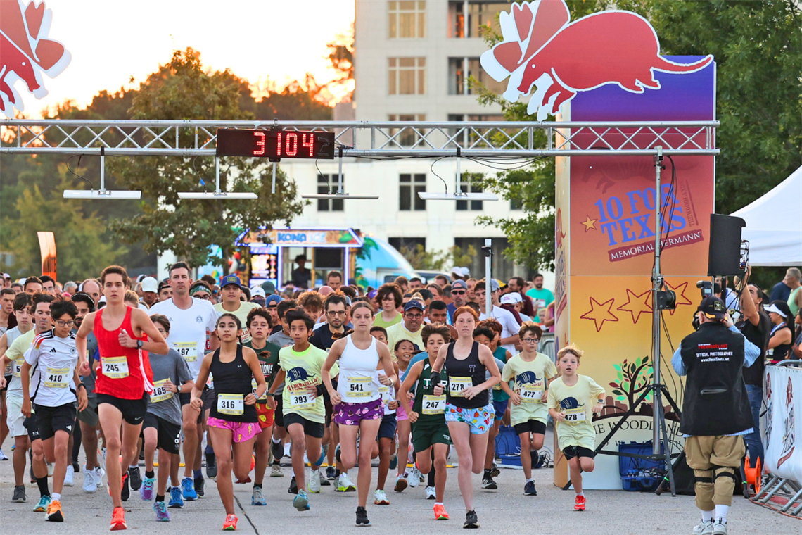 The starting line for a race with many running participants varying in age