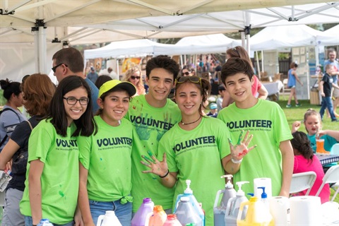 A group of young people with matching t-shirts that read 